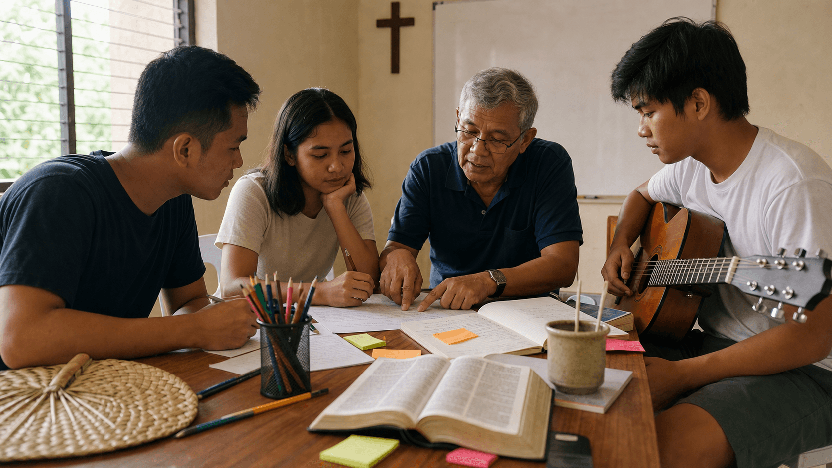 Mixed-age Cebuano songwriters collaborating with Bible, guitar, and lyric drafts