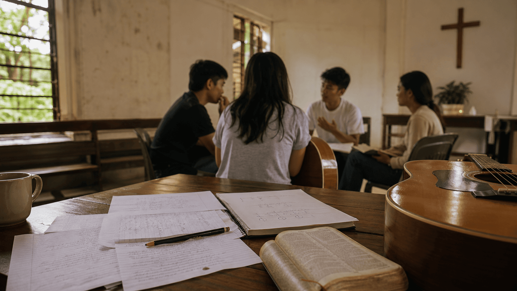 Church songwriters reviewing lyric drafts, a Bible, and guitars in a quiet chapel room